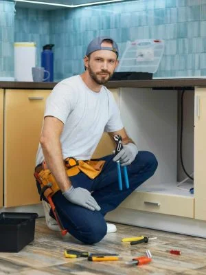 full-length-shot-of-young-handyman-professional-plumber-wearing-tool-belt-looking-at-camera-while.jpg